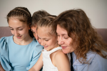 Family, Reading, Togetherness: Three generations bonding indoors by looking at something, sharing a...