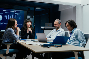 Business executives and assistants brainstorming investment risk evaluation in corporate boardroom
