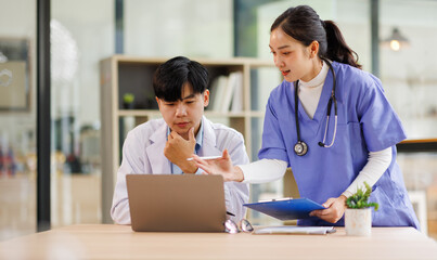 Fototapeta premium Teamwork, laptop and healthcare with a doctor and nurse working together as a team in the hospital. Collaboration, internet and medical with a man and woman surgeon at work on an online diagnosis 