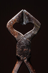 Heart shaped vintage Sugar cutter on a black background. 