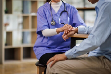 A female nurse hand caregiver holds senior patient's hands, and comfort an elderly. Doctor helping...