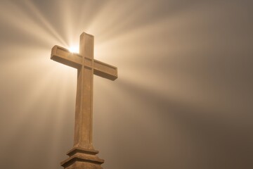Ornate stone cross silhouetted against a foggy background creating a dramatic and cinematic atmosphere for religious themes and reflections