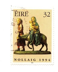 A vintage Christmas postage stamp from Ireland isolated on a white background.