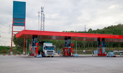 Gasoline pump nozzle sign. Fuel pump petrol station,Oil and Gas station at sunrise and orange sky .