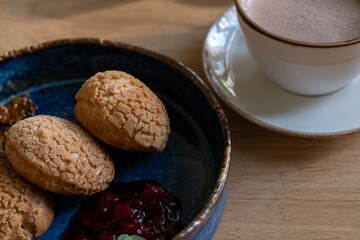 Fresh Pastry with Jam and Cup of Cocoa on Wooden Table