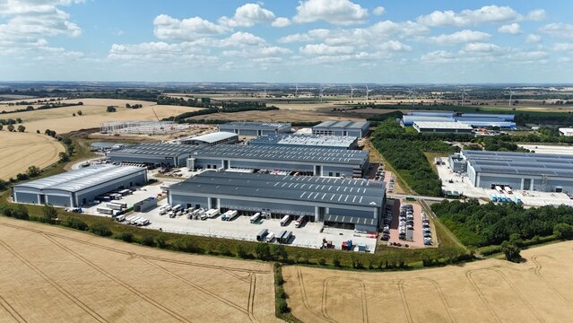 Aerial drone shot of distribution warehouses and data center logistics hub with truck cargo shipping import and export in Biggleswade England UK