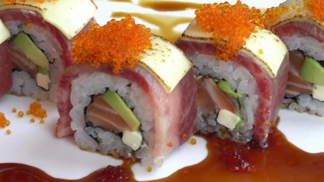 Closeup of a row of sushi rolls with tuna and salmon