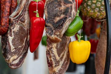 Colorful bell peppers with dried cured meat slices on wooden board appetizer snack rustic flavor