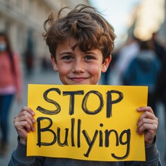 Smiling boy with curly hair holding a bright yellow 'Stop Bullying' sign on a city street, advocating against bullying with confidence