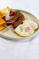 Fried Egg with Sausages and Fresh Sides on Plate