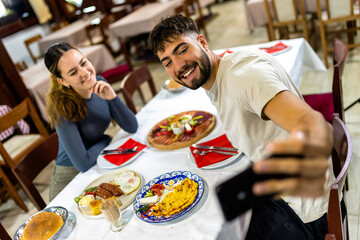  Couple Taking Selfie at Resort Breakfast Table
