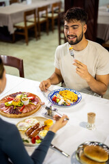  Young Man Eating Breakfast with Girlfriend at Cozy Table
