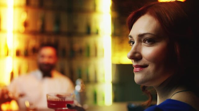 Beautiful red-haired woman enjoying cocktail at bar, hoping to meet someone