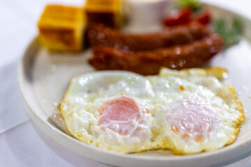 Fried Egg with Sausages and Fresh Sides on Plate