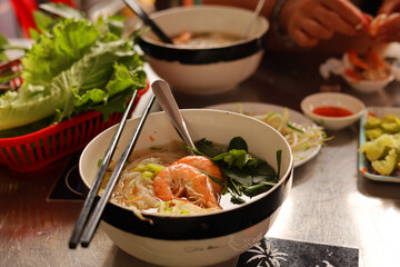Traditional pho soup with seafood and herbs