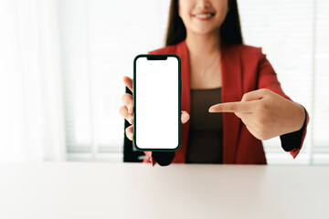 Close-up of young woman holding blank screen smartphone, typing text, chatting with friends on social networks. Concept of using mobile applications, online shopping, opening website