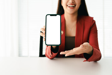 Close-up of young woman holding blank screen smartphone, typing text, chatting with friends on social networks. Concept of using mobile applications, online shopping, opening website