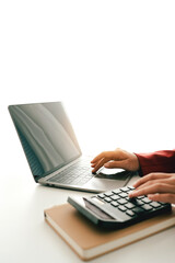 Accountant working at desk using calculator to calculate company's annual financial and tax report. financial concept
