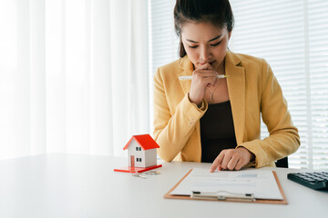 Portrait of a Home Purchase Agreement
Real estate agent delivers a model home to a client,...