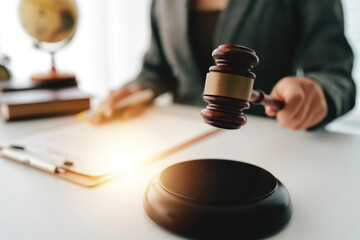 Close-up focuses on judge's hammer on lawyer's table Male consultant or lawyer working in the...
