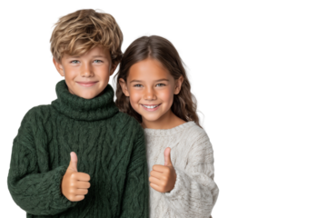 Happy brother and sister in cozy sweaters giving thumbs up and smiling. Family, love, and childhood bond concept