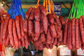 Naturally dried sausages, hanging on colorful strings