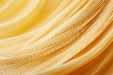 Close-up of pasta texture with yellow strands, smooth surface and twisting lines