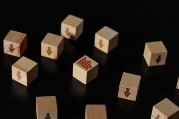 Fototapeta premium Market Downturn and Declining Graph Arrow Wooden Blocks