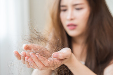 Serious, worried asian young woman, girl holding, show damaged loss hair, problem after brushing,...