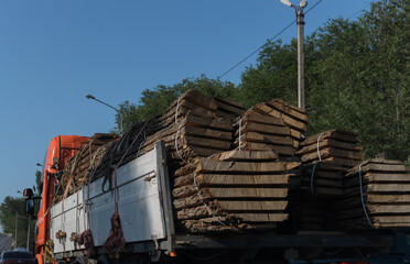 tree trunks sawn lengthwise in the back of a truck