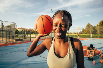 Outdoor basketball black woman fun on a sunny court