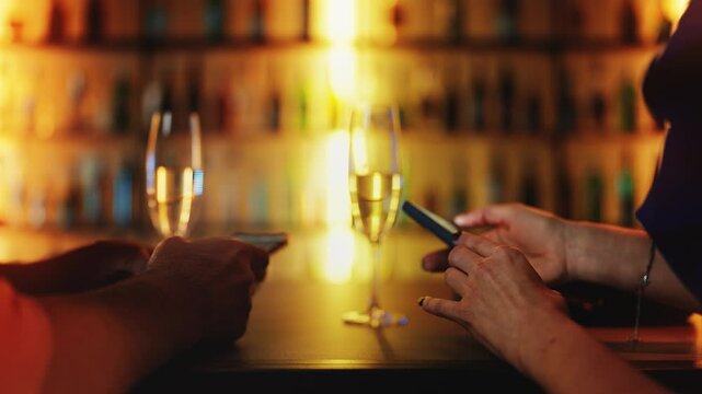 Woman and her boyfriend scrolling phones during date, lack of conversation