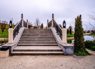 Stone staircase to the bridge over the pond in the park.