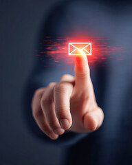 A person"s finger is pressing a glowing digital envelope icon, symbolizing sending or receiving an email message through technology.