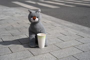 This charming and adorable plush wolf is sitting comfortably with a delightful coffee cup