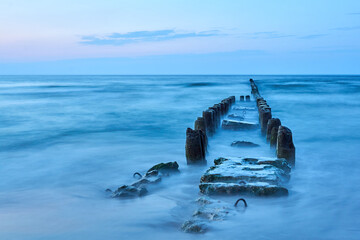 Old wooden breakwater on the Baltic coast in the evening