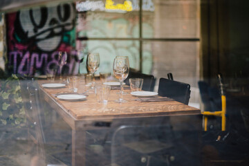 Set table behind glass window in urban restaurant