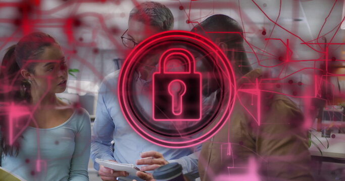 Reviewing team using notepad in open plan office, with neon padlock hologram and network circuitry