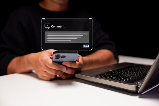 A person holding a smartphone near a laptop, with a digital comment box overlay indicating online communication or social media interaction.