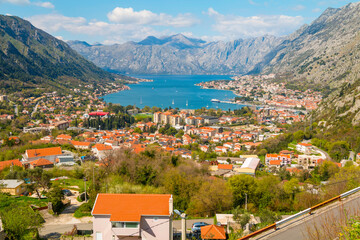 From high above Kotor, the view reveals a spectacular blend of red rooftops, deep blue waters of...
