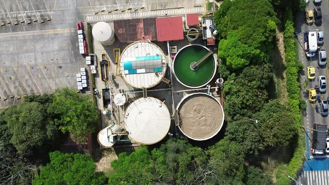 Aerial Drone View of Industrial Tanks with Boiling Liquids Inside