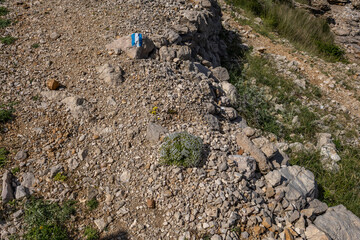 View of the beach from the top of the mountain, rocky trail leading to the picturesque beach