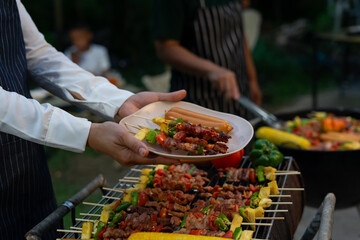 Grilled skewers and sausages served at outdoor barbecue