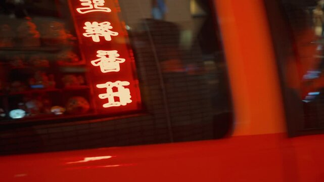 Red taxi leaving at night in hong kong