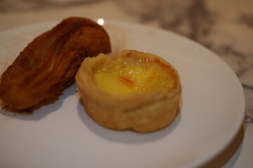 Portuguese Egg Tart and Churros on White Plate