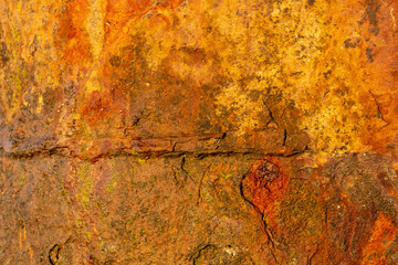 Detailed close-up of rusty steel surface showcasing corrosion marks, orange patina and aged metal texture ideal for backdrops, posters and digital art compositions.