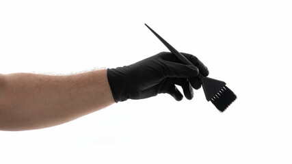 Hand with black brush on white background