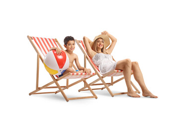 Mother and son on a summer vacation, sunbathing on loungers