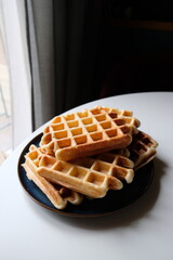 belgian waffles on blue plate and white table