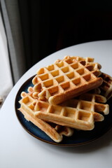 belgian waffles on a plate and white table